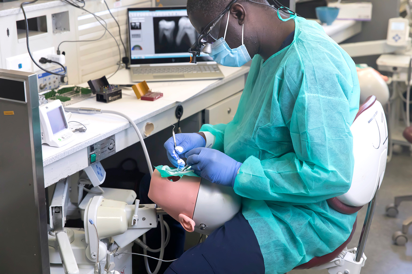Ostrow ASPID student performs root canal treatment in the simulation laboratory. | NATE JENSEN