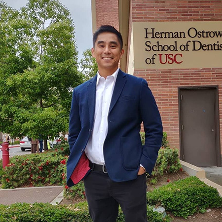 Danilo Diangkinay standing in from of the Herman Ostrow School of Dentistry of USC