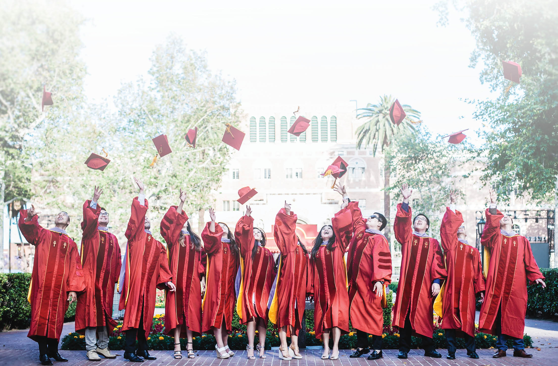 Grads tossing caps into the air