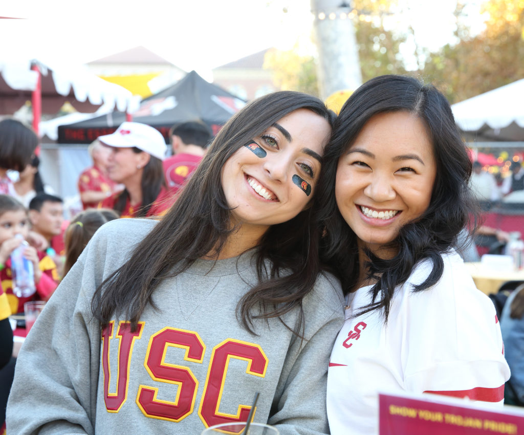 Two women with USC clothing on at tailgate party