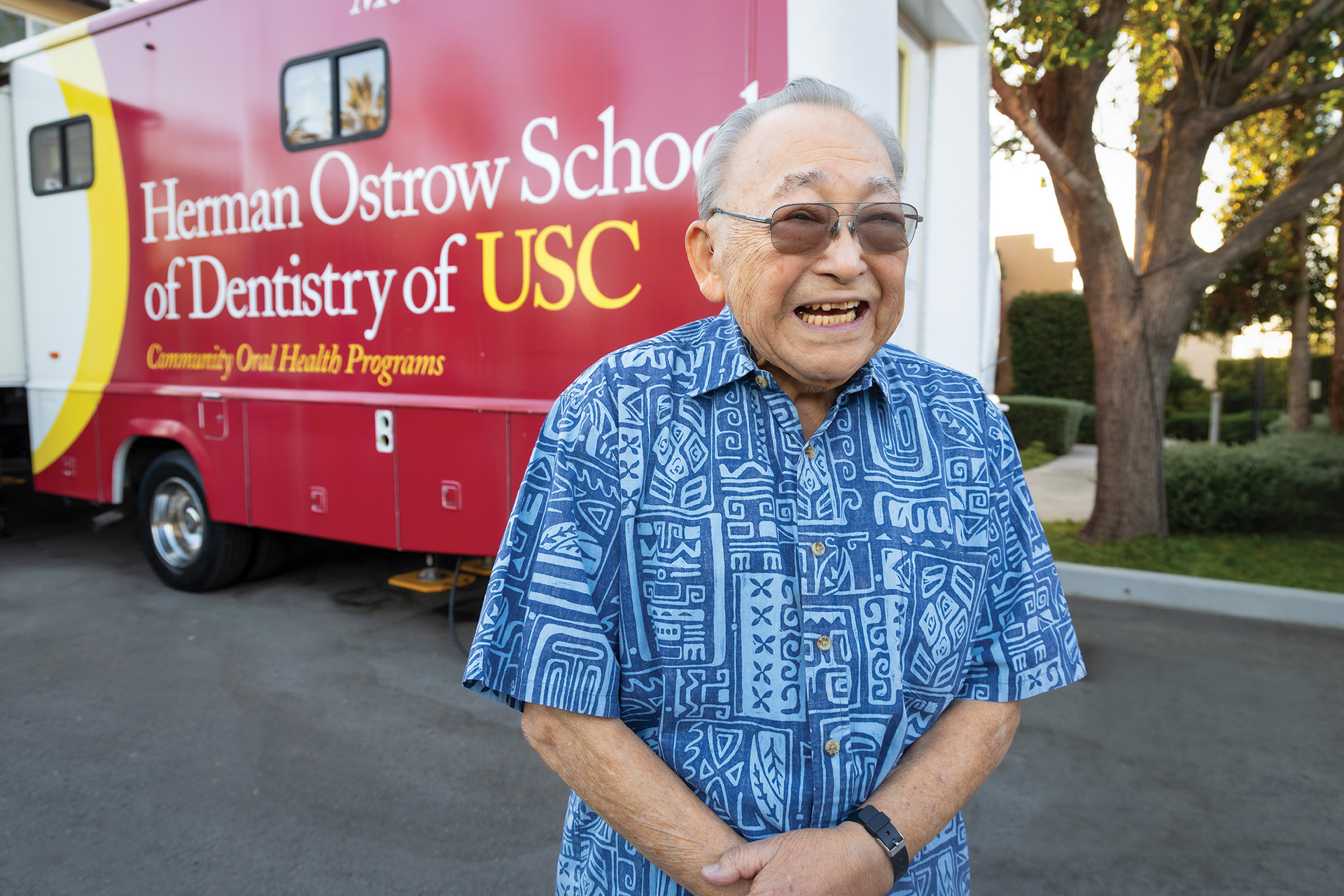 Paul Kamachi in front of the USC Mobile Dental Clinic.